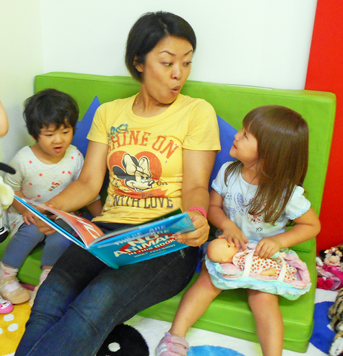 Woman reading to engaged children – building language skills and emotional connection through books