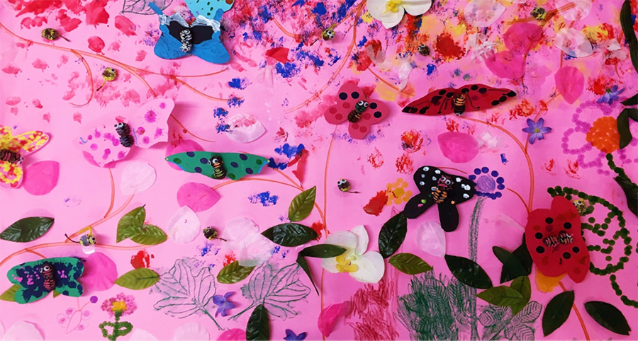 Child-created butterfly collage on pink background – celebrating nature and artistic self-expression
