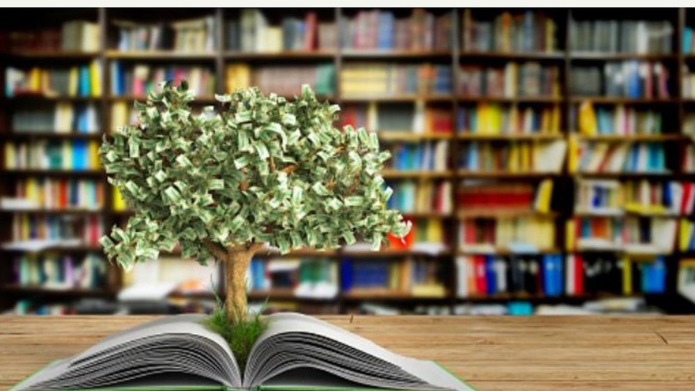 Tree made of money sprouting from an open book in front of library shelves, symbolizing education