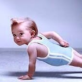 Baby doing a one-arm push-up, symbolizing strength and early childhood development